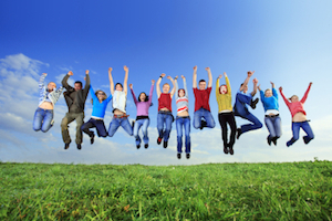 Big group of young jumping people.