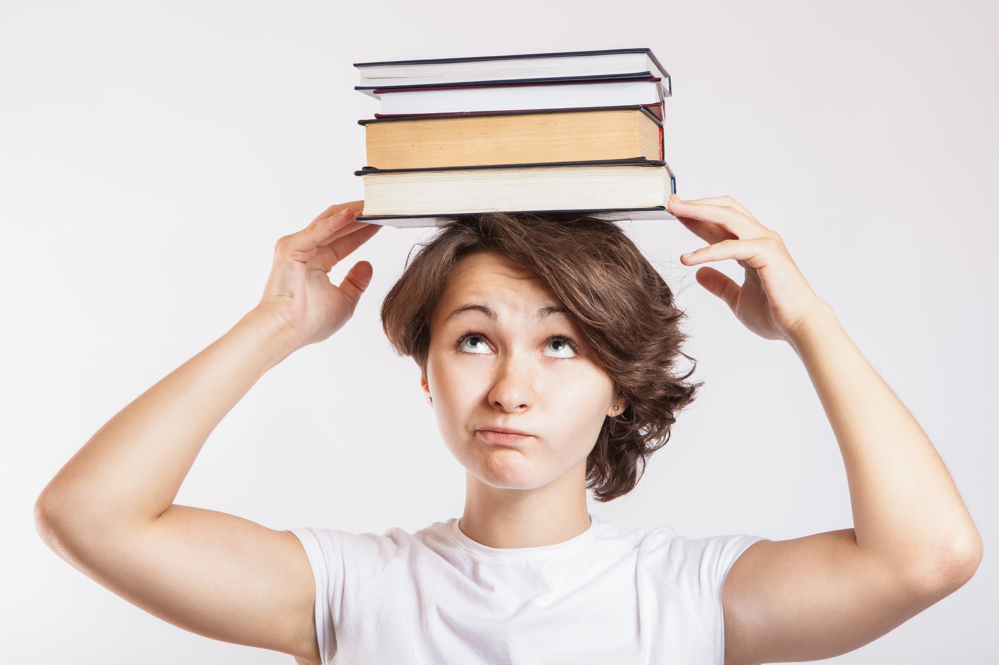 CollegeDegree360-Schoolgirl with books on head